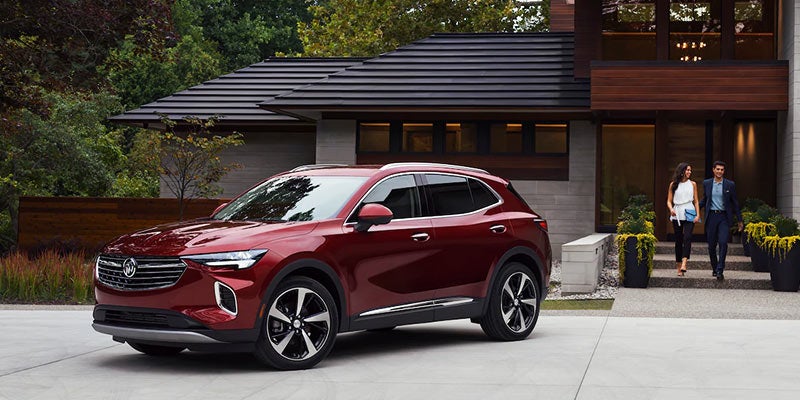 Red buick envison park in front of row house