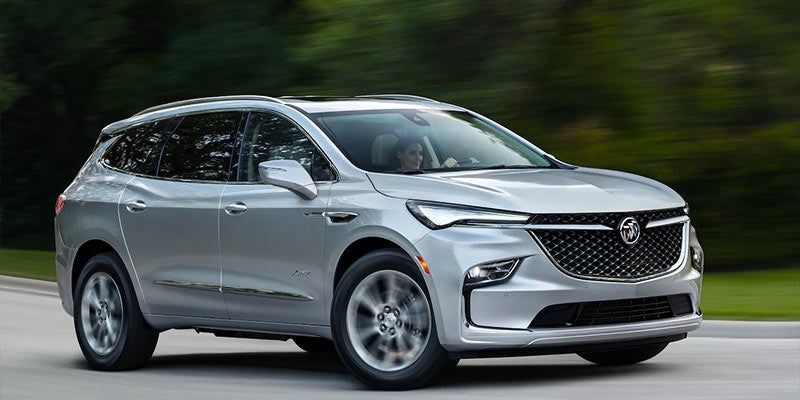 2022 Buick Enclave driving down a paved road