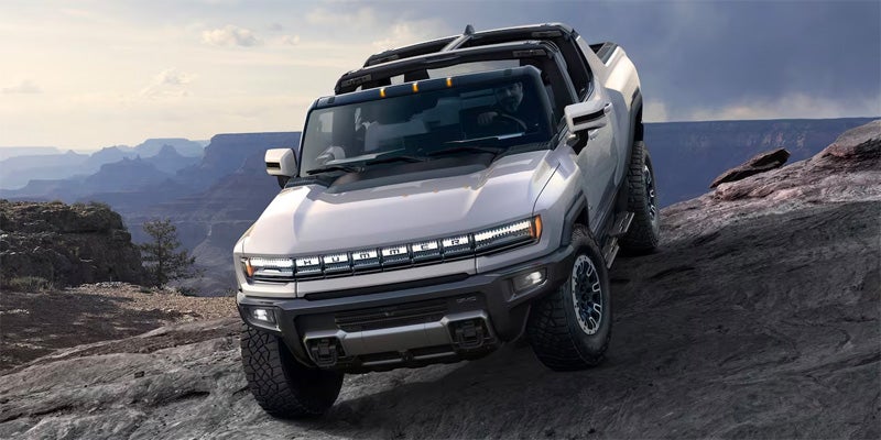 GMC Hummer EV Pickup Vehicle Parked On The Top Of A Mountain