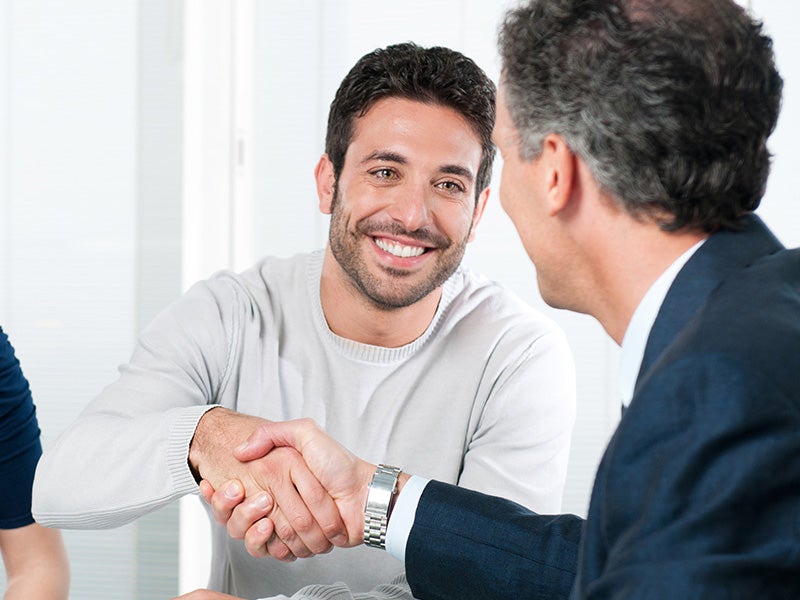 Dublin Buick GMC in Dublin CA customer shaking hands with sales rep