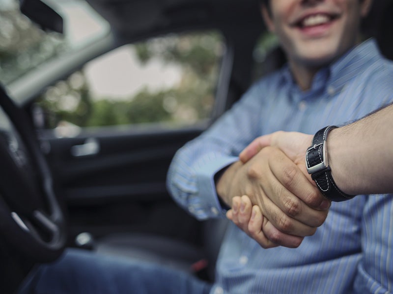 Dublin Buick GMC in Dublin CA sales rep shaking hands with customer