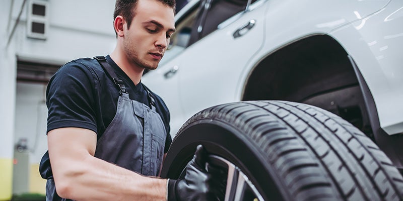 Dublin Buick GMC in Dublin CA technician changing a tire