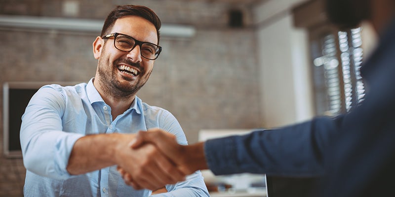 Dublin Buick GMC in Dublin CA sales rep shaking customers hand