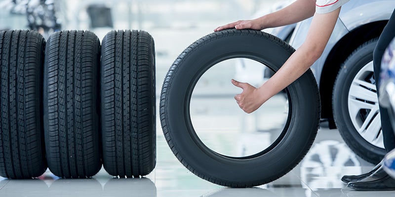 Dublin Buick GMC in Dublin CA technician rolling a tire